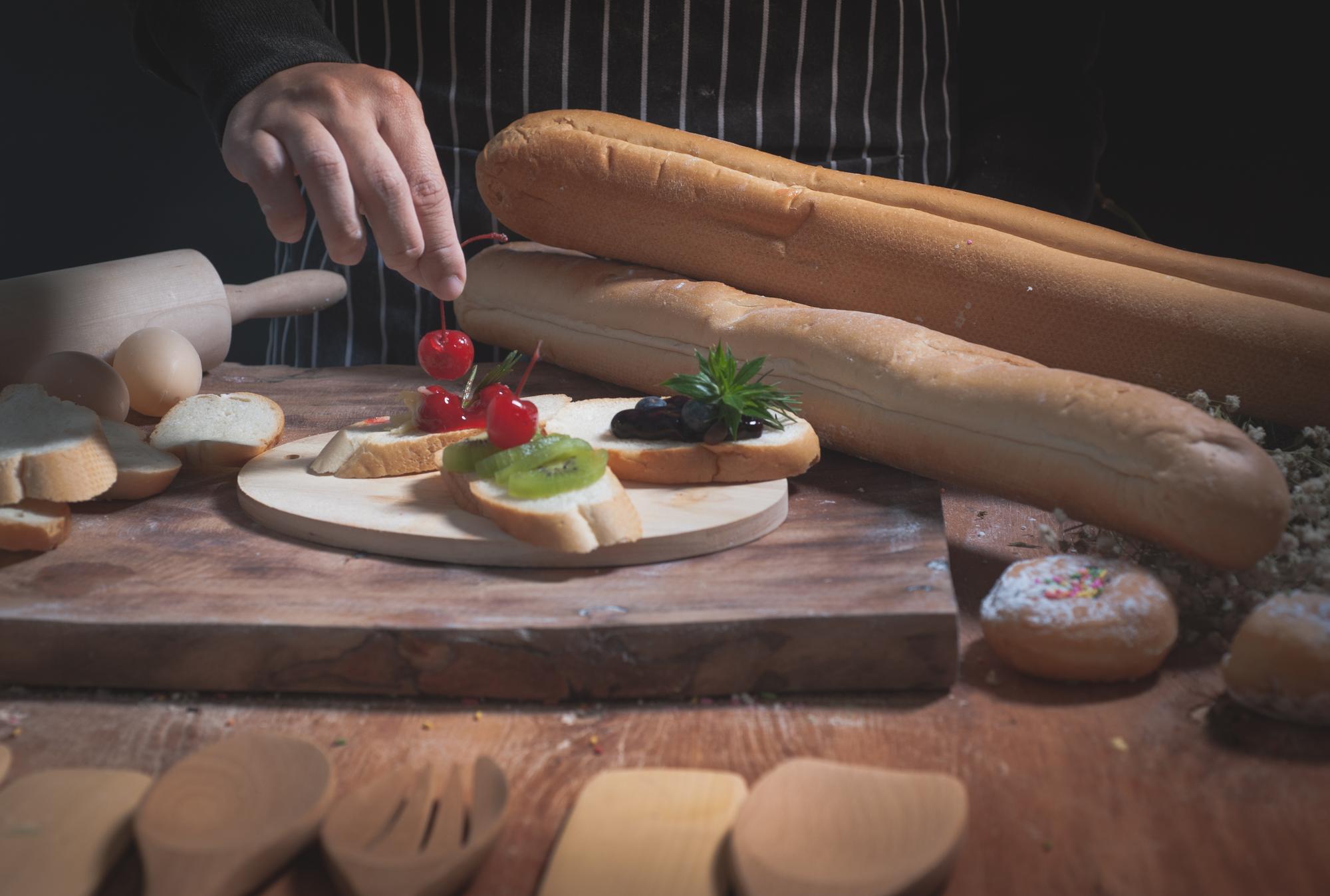 Chef at wooden table preparing ingredients